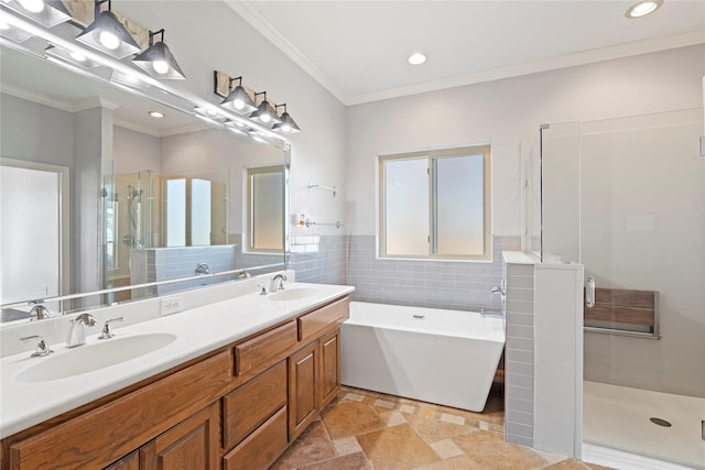 full bathroom featuring a stall shower, a soaking tub, and a sink