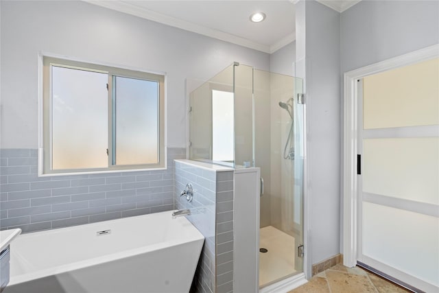 full bathroom with ornamental molding, a stall shower, a soaking tub, and recessed lighting