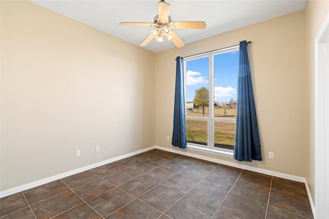 spare room with baseboards and a wealth of natural light