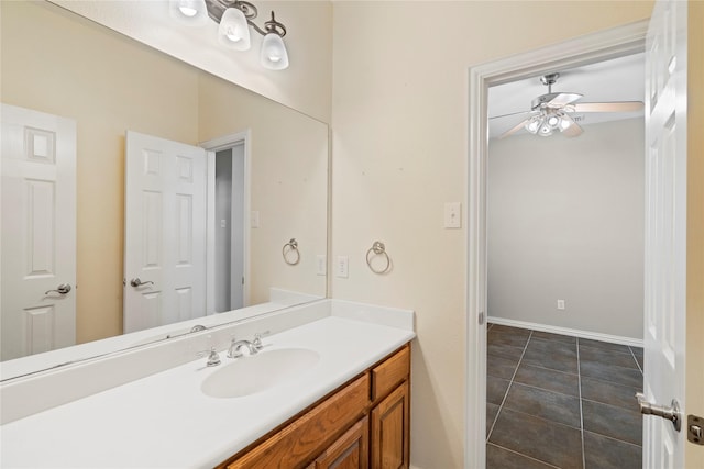 bathroom featuring baseboards, tile patterned floors, vanity, and a ceiling fan