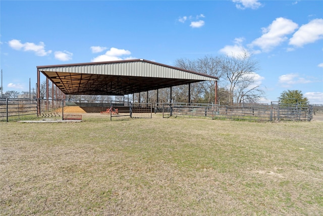 view of yard featuring a rural view and a covered structure