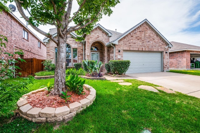 view of front of home featuring a garage, driveway, a front yard, and brick siding