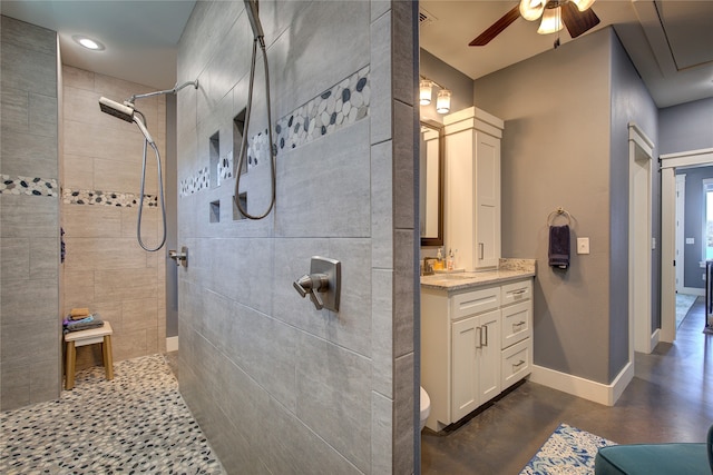 full bath with baseboards, a ceiling fan, concrete flooring, vanity, and a walk in shower