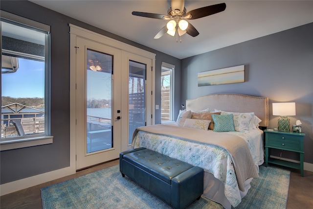 bedroom with baseboards, multiple windows, and access to exterior