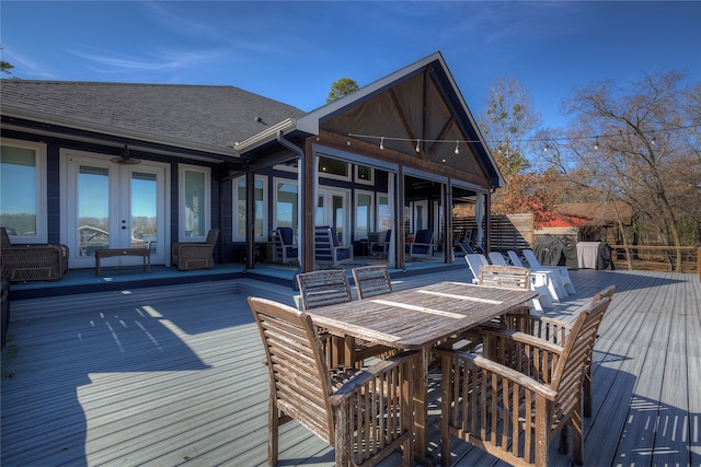 wooden deck with french doors and outdoor dining area