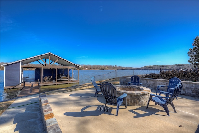 view of patio / terrace featuring a water view and an outdoor fire pit