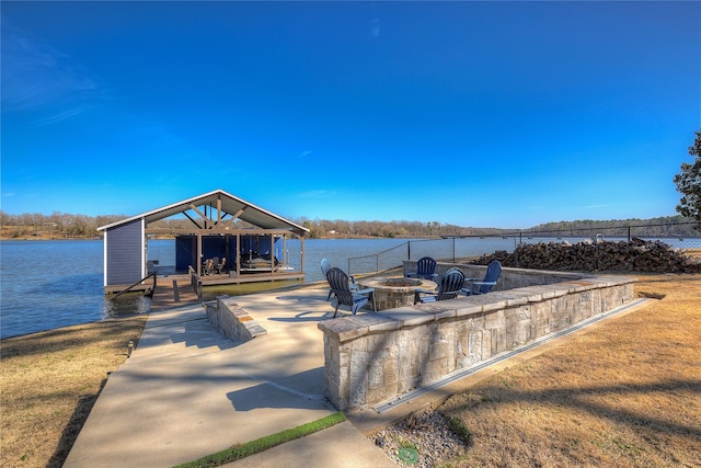 view of dock featuring a fire pit and a water view