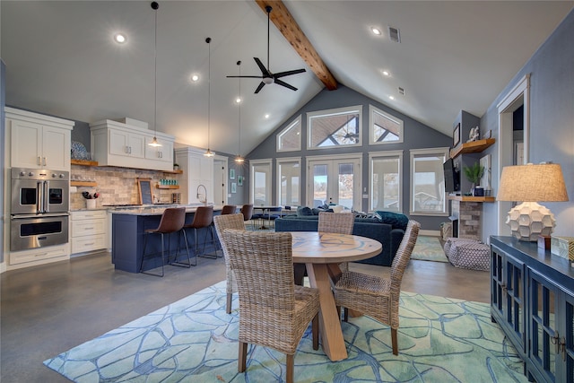 dining area with high vaulted ceiling, visible vents, finished concrete flooring, french doors, and beam ceiling