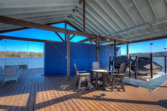 wooden terrace featuring a dock, a water view, and boat lift