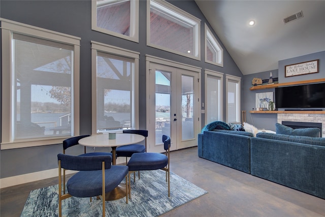 living room with high vaulted ceiling, concrete floors, visible vents, baseboards, and french doors