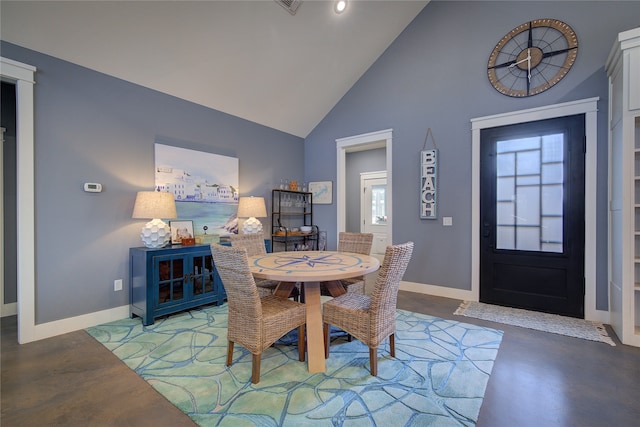 dining space featuring finished concrete flooring, a healthy amount of sunlight, and baseboards