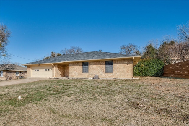 view of front facade featuring a garage, a front lawn, concrete driveway, and brick siding