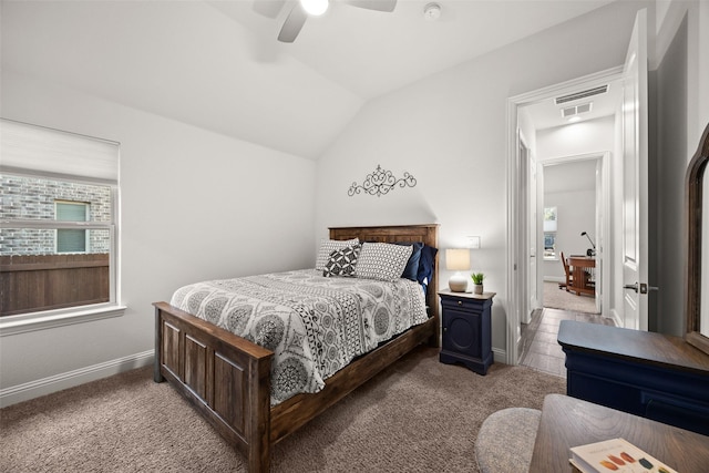 bedroom with light carpet, multiple windows, vaulted ceiling, and ceiling fan