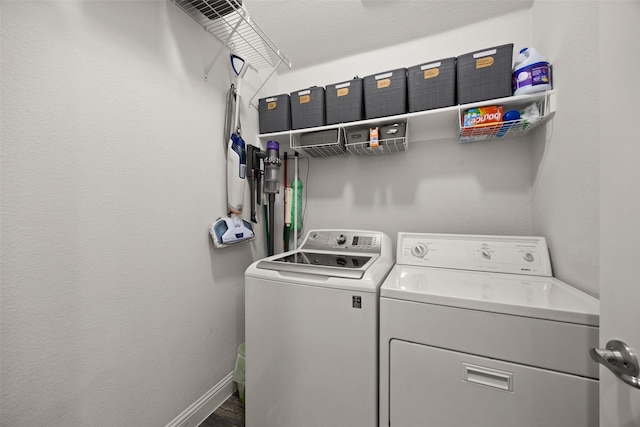 laundry area featuring laundry area, baseboards, and separate washer and dryer