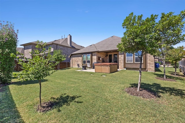 exterior space featuring a patio area, a fenced backyard, and a hot tub