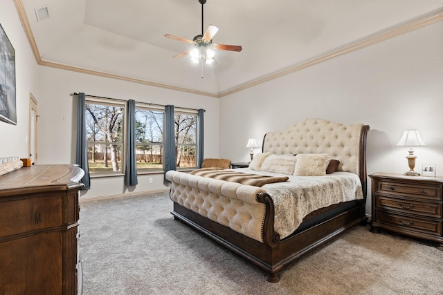 bedroom featuring a tray ceiling, crown molding, light carpet, ceiling fan, and baseboards