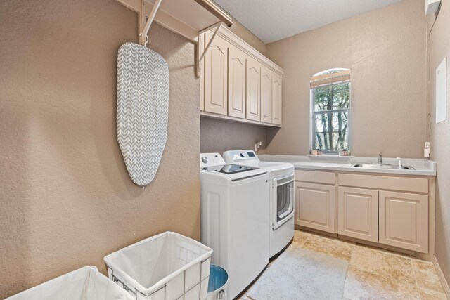 5809 Downing Ln, Joshua, TX 76031 - laundry area with cabinet space, washer and clothes dryer, light stone finish floors, and a textured wall