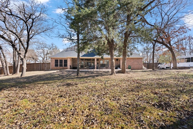 exterior space with fence and brick siding