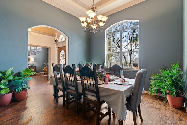 dining space featuring arched walkways, a healthy amount of sunlight, a notable chandelier, and hardwood / wood-style flooring