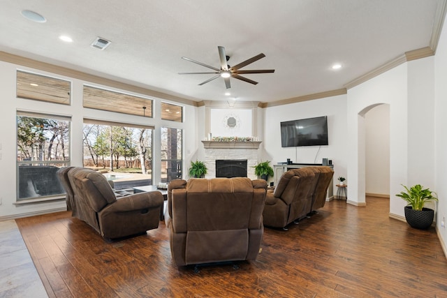 5809 Downing Ln, Joshua, TX 76031 - living room with ceiling fan, arched walkways, a fireplace, ornamental molding, and dark wood-type flooring