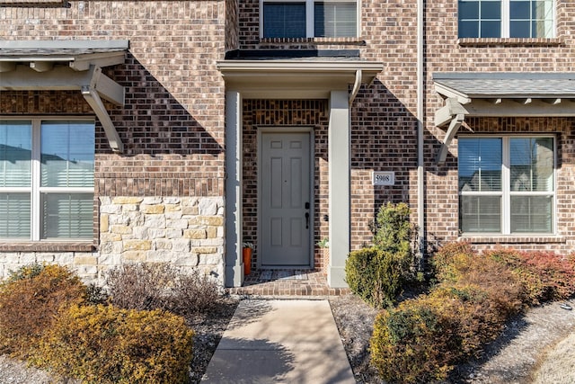 doorway to property with brick siding