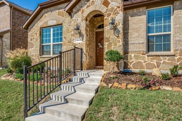 doorway to property with stone siding