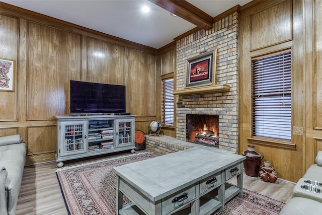 living room with light wood-type flooring, beam ceiling, a fireplace, and wooden walls