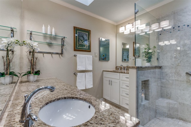 bathroom featuring crown molding, a sink, a tile shower, and double vanity