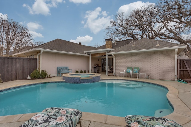 view of pool featuring a pool with connected hot tub, fence, and a patio