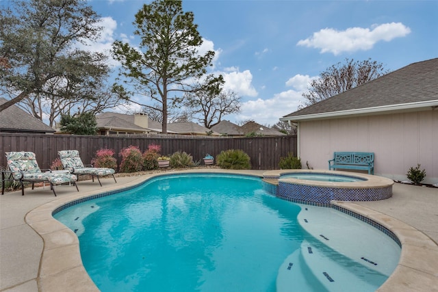 view of swimming pool featuring a fenced backyard, a pool with connected hot tub, and a patio