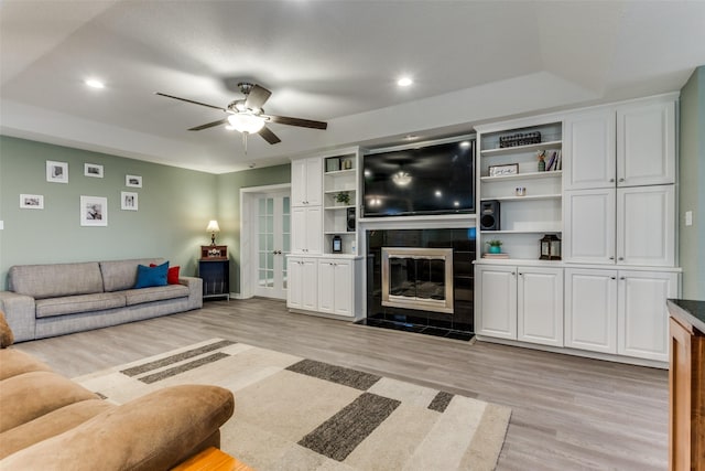 living area featuring light wood finished floors, a fireplace, a ceiling fan, and recessed lighting