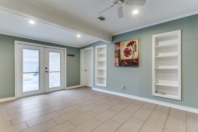 empty room with french doors, built in shelves, visible vents, and baseboards