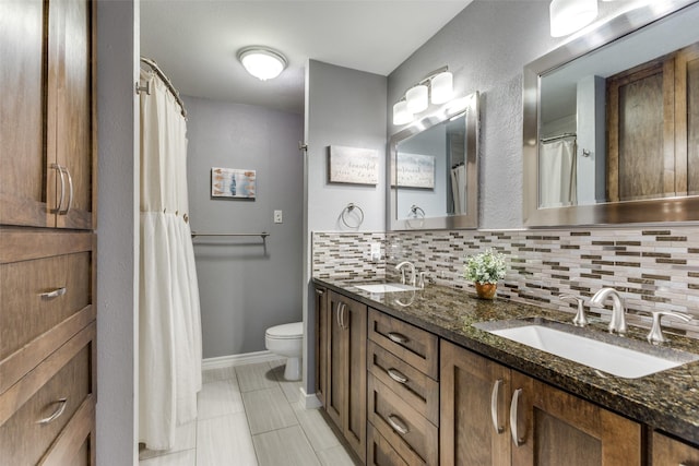 full bathroom with double vanity, toilet, decorative backsplash, and a sink