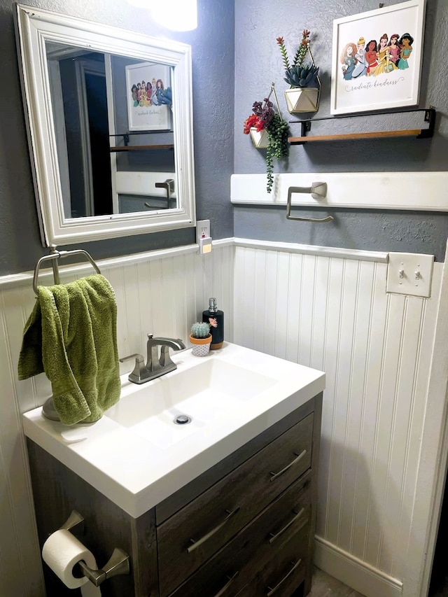 bathroom with wainscoting and vanity