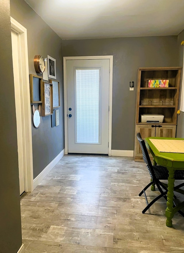 entryway featuring light wood finished floors and baseboards