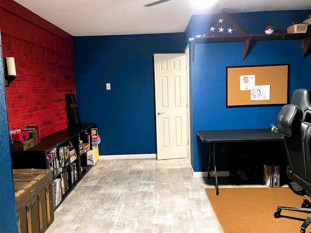 office area with baseboards and light wood-style floors