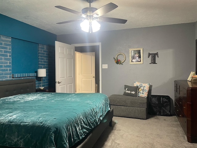 bedroom with a ceiling fan, a textured ceiling, and light colored carpet