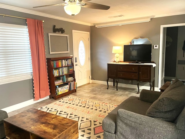 living room featuring ornamental molding, visible vents, ceiling fan, and baseboards