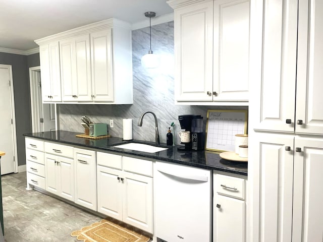 kitchen featuring dark countertops, white cabinets, white dishwasher, and a sink