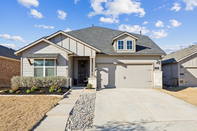 view of front of property with driveway, a garage, board and batten siding, and roof with shingles