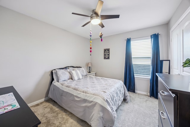 bedroom featuring light colored carpet, ceiling fan, and baseboards