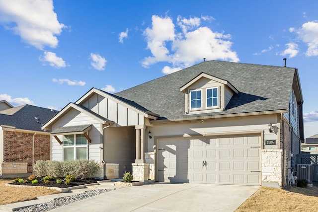 view of front facade featuring driveway, a garage, stone siding, roof with shingles, and board and batten siding