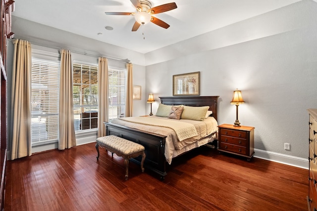 bedroom featuring dark wood-style flooring, ceiling fan, and baseboards