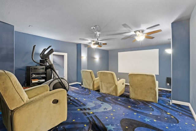 cinema featuring ceiling fan, baseboards, and carpet flooring