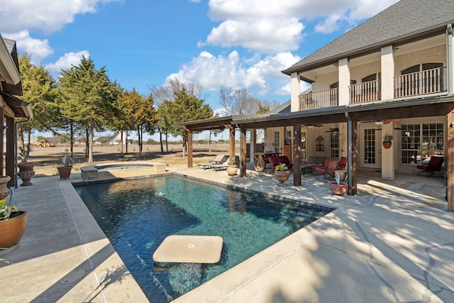 outdoor pool featuring a ceiling fan, outdoor lounge area, a patio, and an in ground hot tub