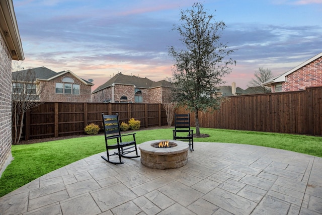 view of patio featuring an outdoor fire pit and a fenced backyard