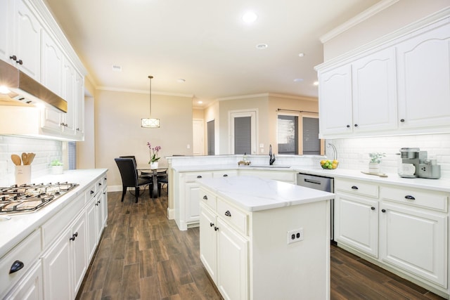 kitchen featuring white cabinetry, pendant lighting, a sink, and a center island