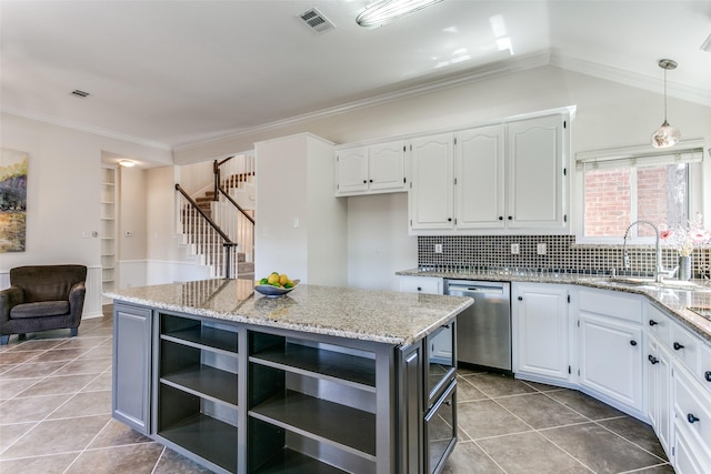 kitchen with visible vents, a sink, white cabinets, stainless steel dishwasher, and crown molding