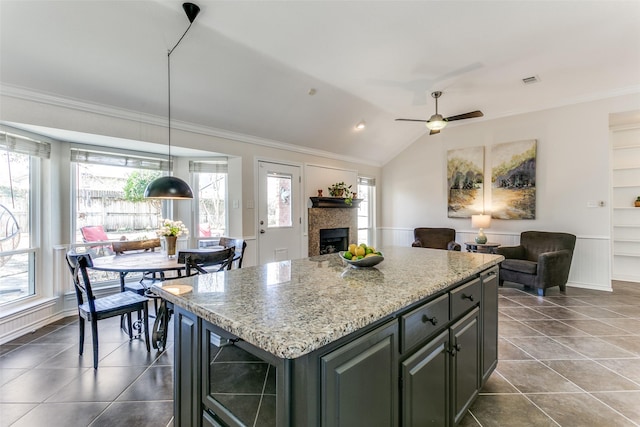 kitchen with wine cooler, a fireplace, open floor plan, and ornamental molding