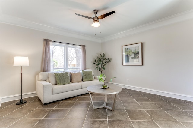 living area with baseboards, a ceiling fan, crown molding, and tile patterned flooring